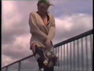 Grown blondynka nagi pod coat walking na overbridge.
